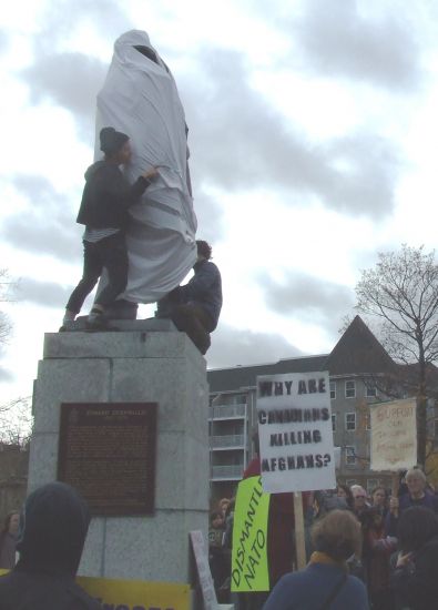 Commemorative statue shamelessly honouring the Genocidaire Cornwallis is covered by anti-war activists at protest against the Halifax International Security Forum, November, 20010. The rally renamed “Cornwallis Park” Peace & Freedom Park as a tribute to the heroic struggle of the First Nations against imperialist war and conquest, including the present-day stand of the Innu against NATO training flights in Labrador.