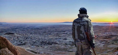 Hezbollah resistance fighter greeting the morning sunrise on the day of victory in Yabroud in the the hotly-contested Qalamoun Mountain region, March, 2014. That's what liberation looks like. (Click to enlarge)