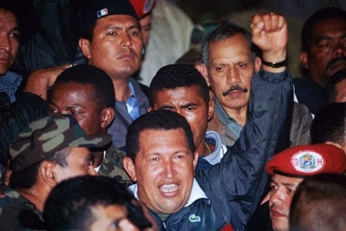 President Chávez raises a defiant fist after the people defeat the coup and he is released on April 14, 2002.